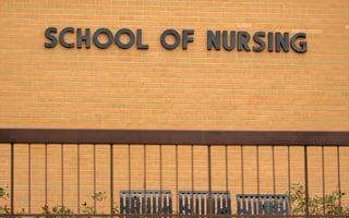 School Of Nursing Sign On Brick Wall